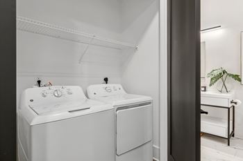 A white washing machine and dryer in a laundry room.
